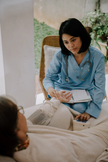 Hospice_nurse_caring_for_patient_at_home.png